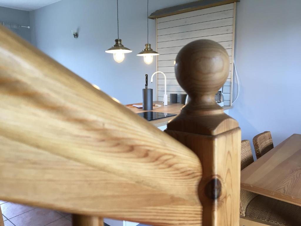 a wooden rail in a kitchen with a table at Apartmenthaus Lütt Meer in Ludorf