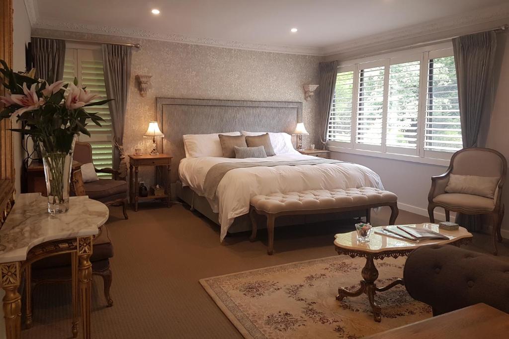1 dormitorio con 1 cama grande y sala de estar en Villa d'Amour, en Mount Dandenong