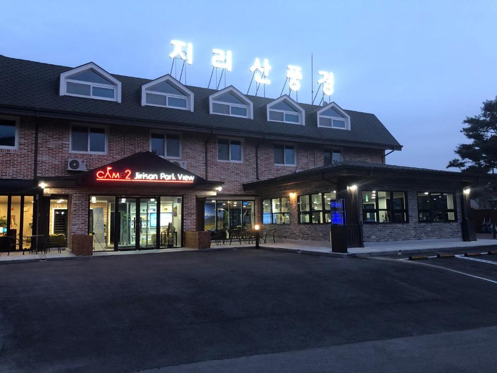 un bâtiment avec des moulins à vent en haut dans l'établissement CAMP Jirisan Parkview, à Gurye