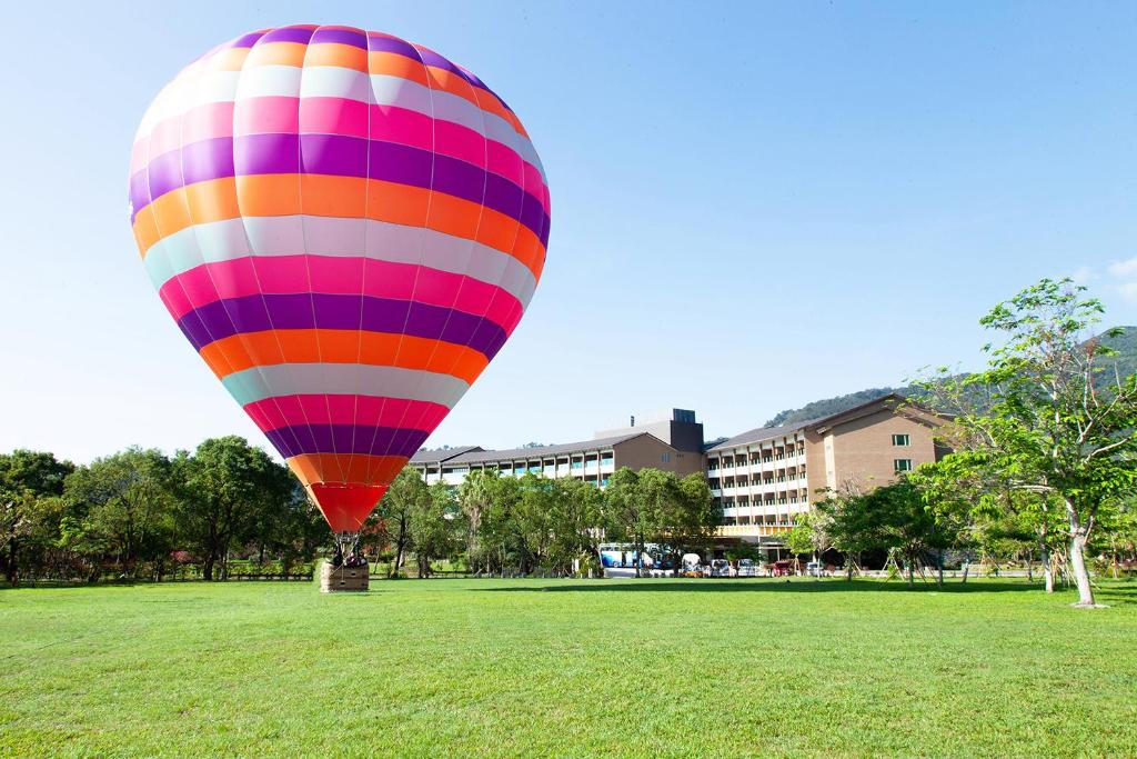 a colorful hot air balloon in a field at Luminous Hot Spring Resort &amp; SPA in Luye