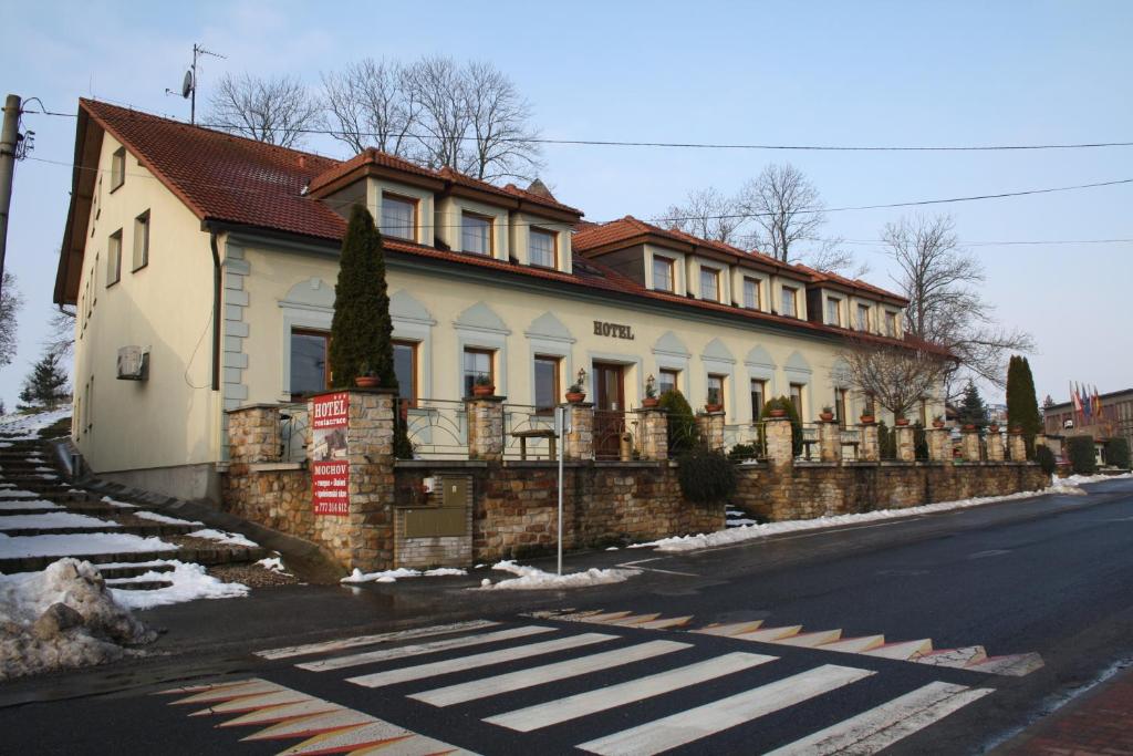 a house on the side of a street with a crosswalk at Hotel Bouček in Mochov