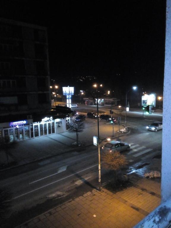 a city street at night with cars on the road at Lara in Doboj