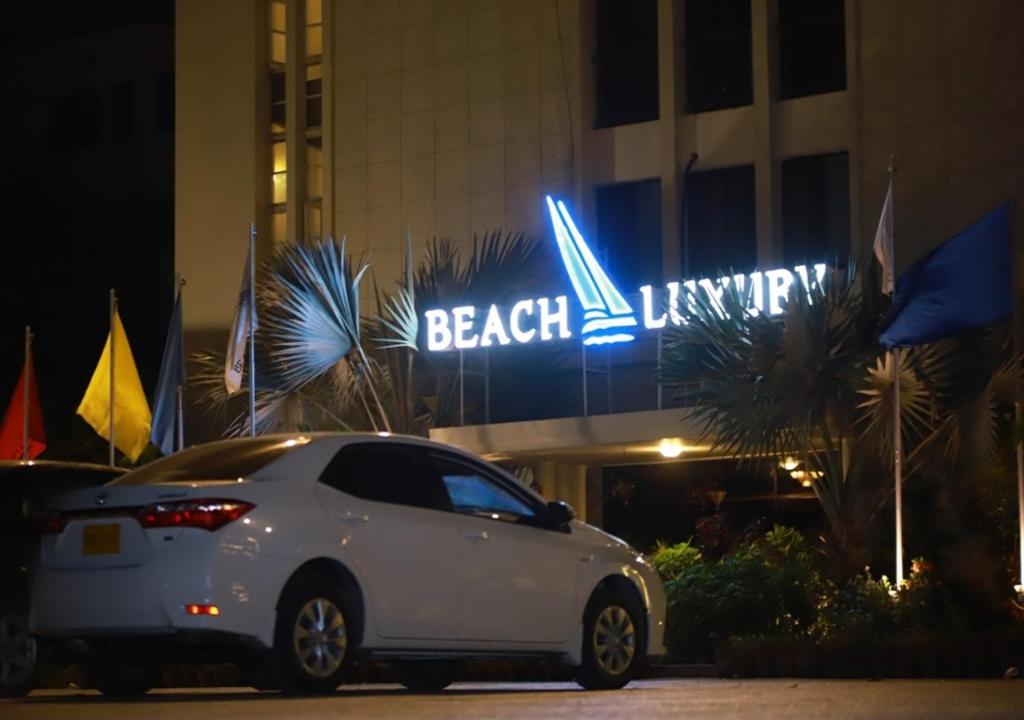 a car that is parked in front of a building at Beach Luxury Hotel in Karachi