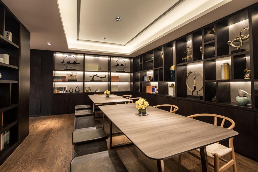 a dining room with two tables and chairs at Somerset Harmony City Wuxi in Wuxi