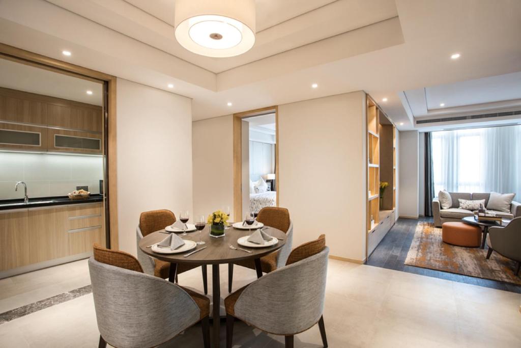 a dining room with a table and chairs at Somerset Harmony City Wuxi in Wuxi