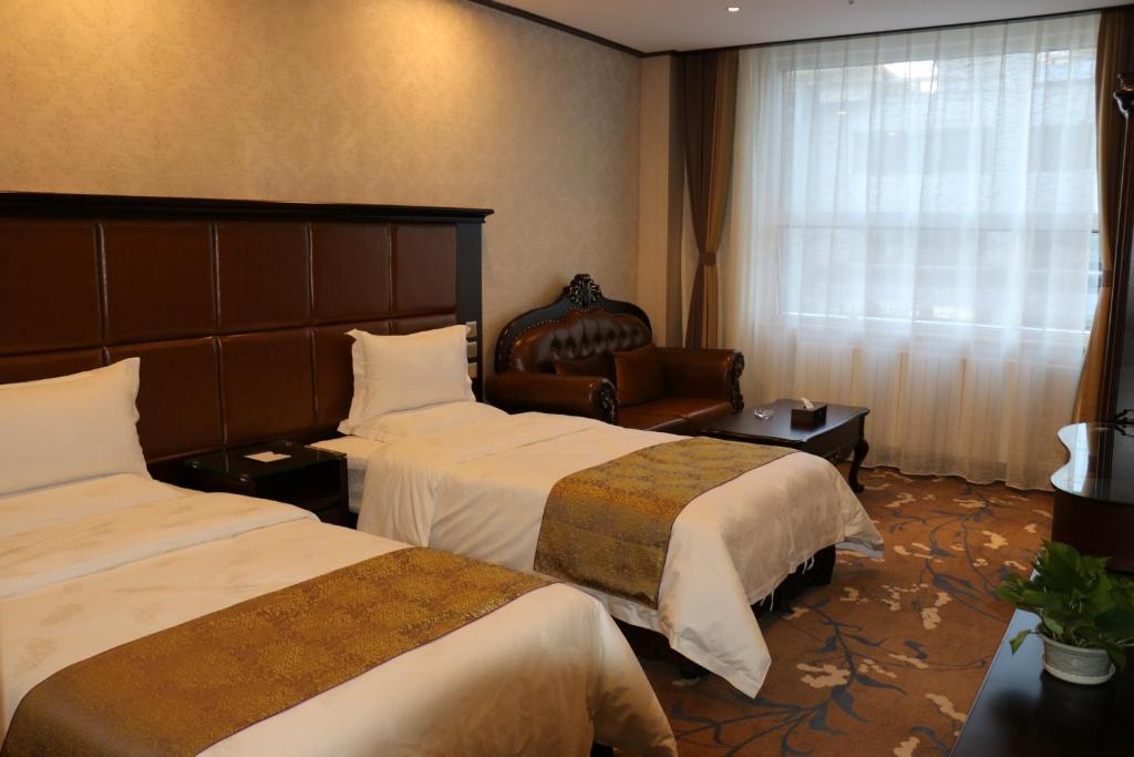 En eller flere senger på et rom på Hohhot Level of Details