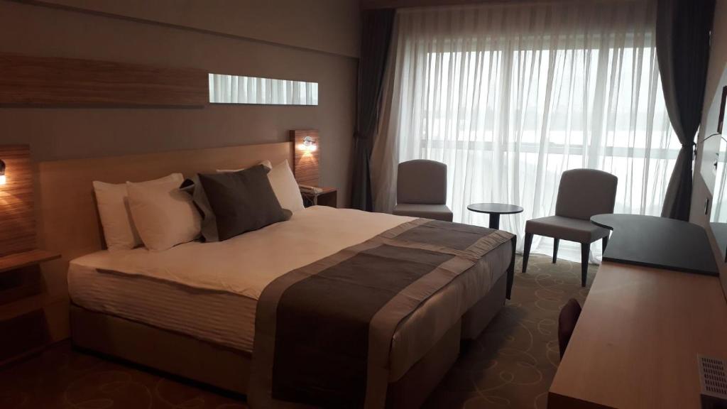 a hotel room with a bed and a window at Greymark Hotel in Izmir