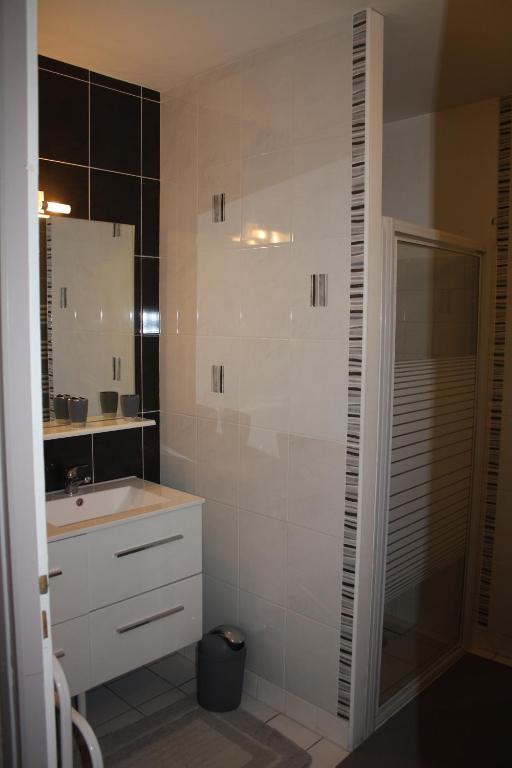 a bathroom with a sink and a mirror at Gite De LA BALLADE in François