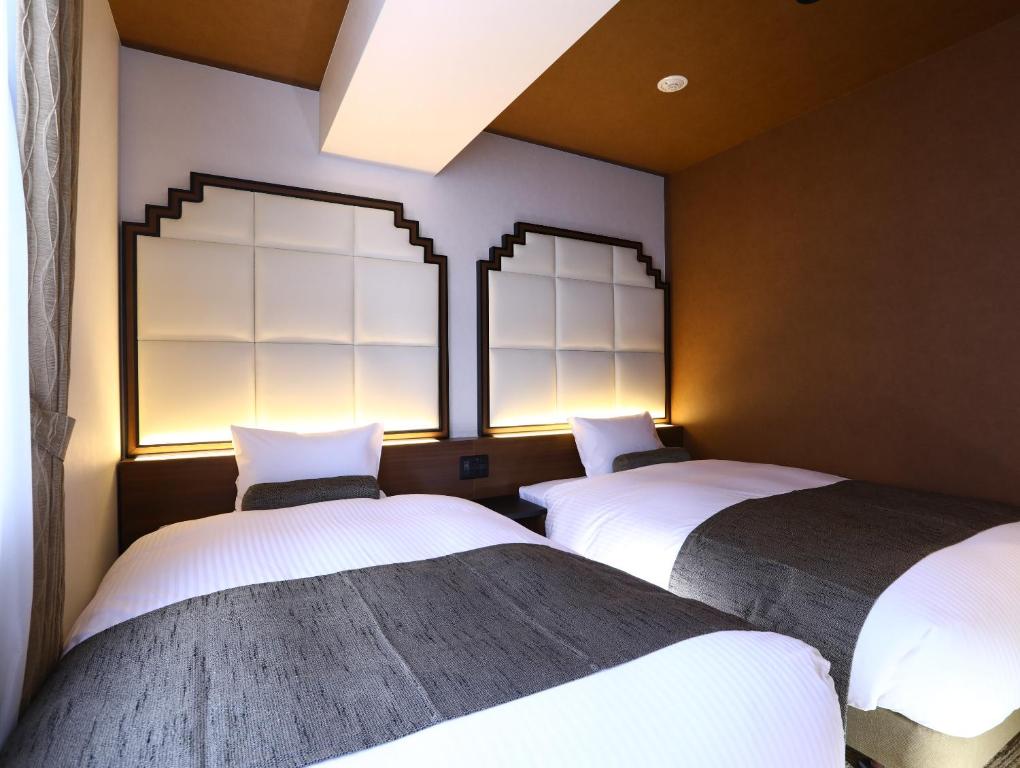 Postel nebo postele na pokoji v ubytování Hotel Wing International Select Osaka Umeda