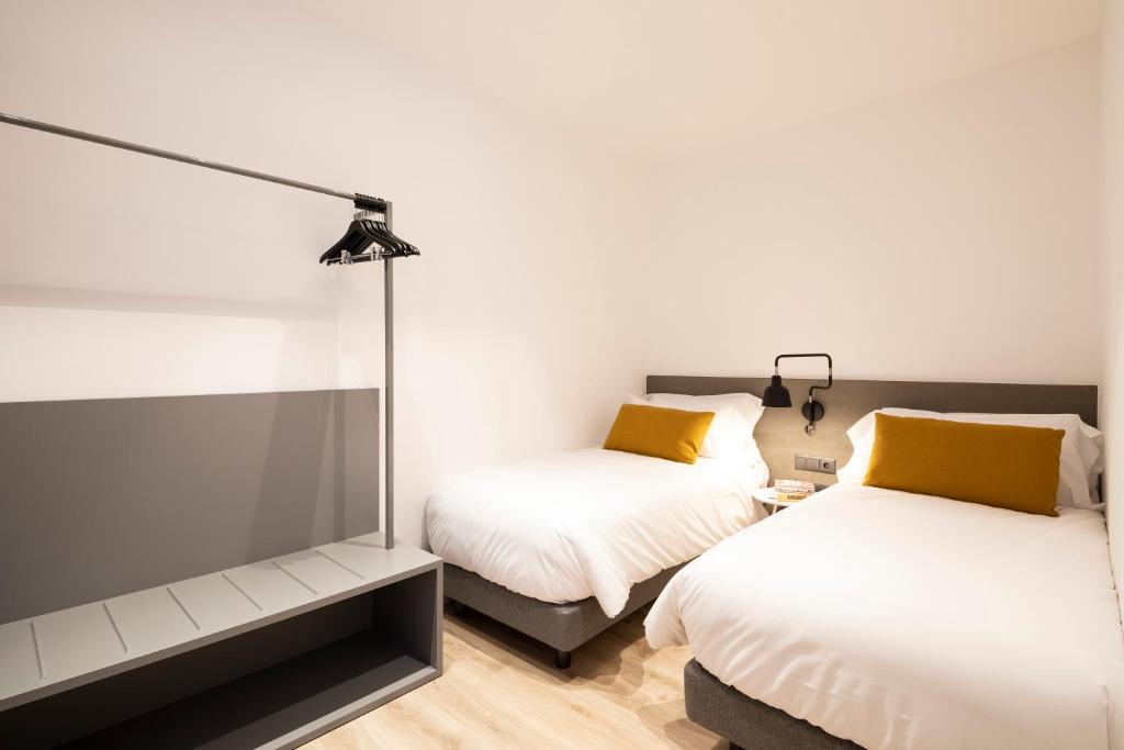 A bed or beds in a room at Aspasios Sagrada Familia Apartments