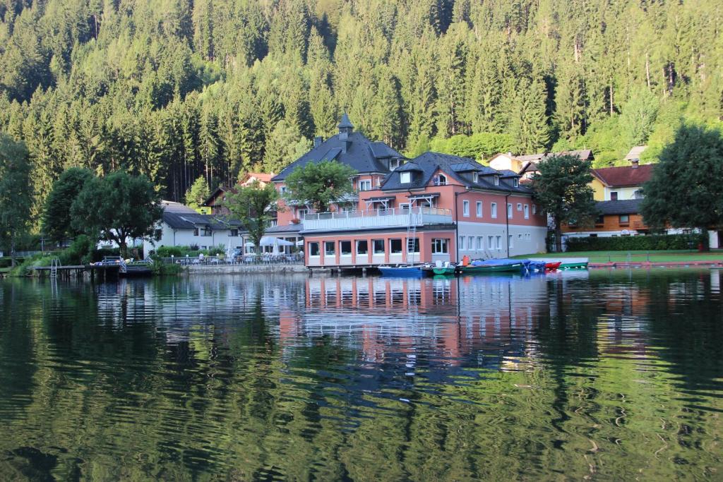 a large building on the side of a lake at Seeappartement " Seerose" in Feld am See