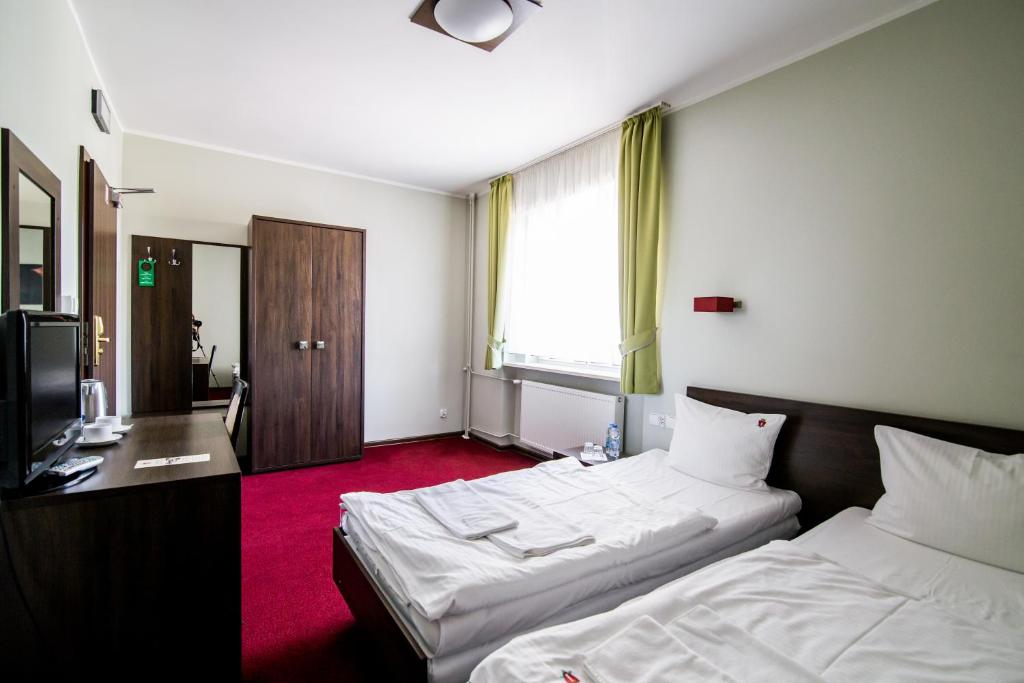 Postel nebo postele na pokoji v ubytování Hotel Walewscy