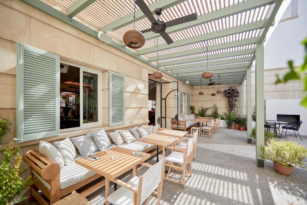 a living room filled with furniture and a patio at M House Hotel in Palma de Mallorca