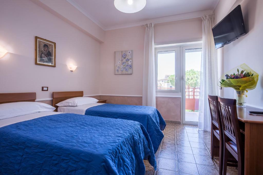 Postel nebo postele na pokoji v ubytování Hotel Casa Tra Noi