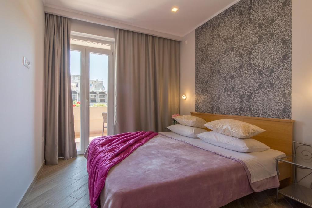 Posteľ alebo postele v izbe v ubytovaní Apartments Smokva