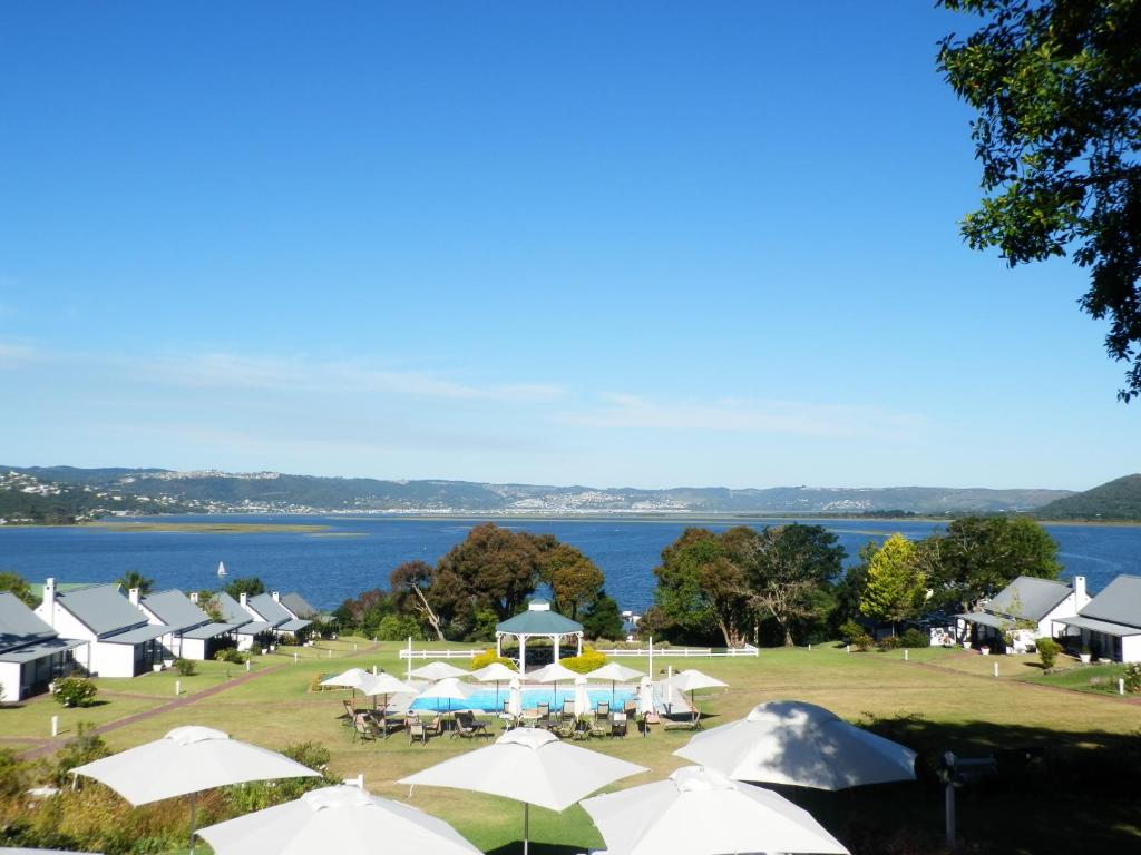 a group of tents and a large body of water at Belvidere Manor Lagoonside Cottages in Knysna