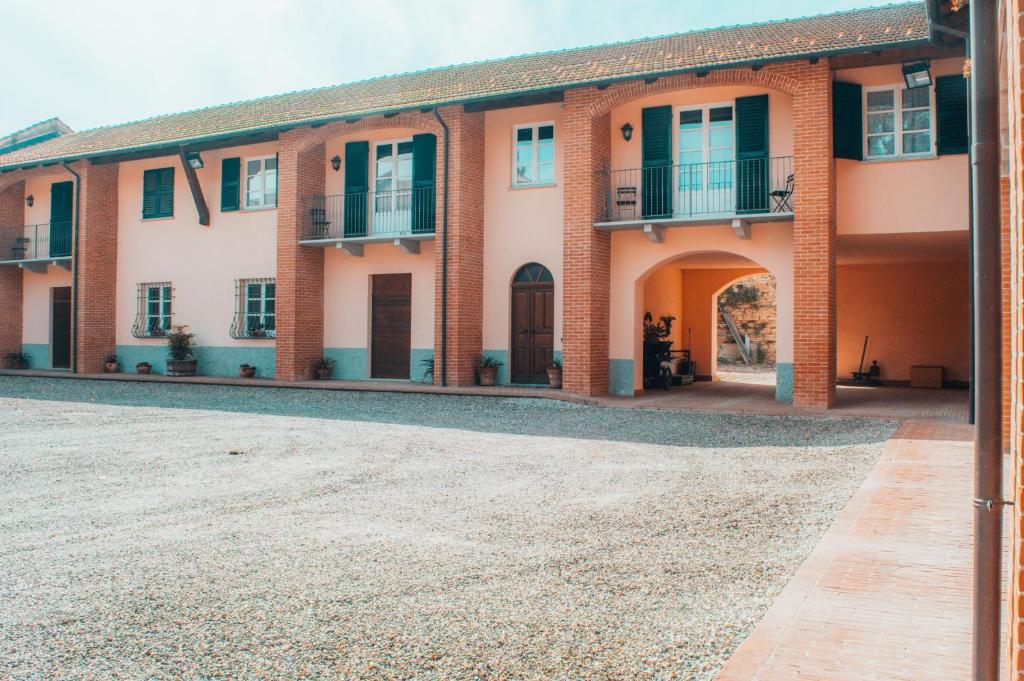 an exterior view of a building with a courtyard at Agriturismo Villa Caffarelli in Monastero Bormida