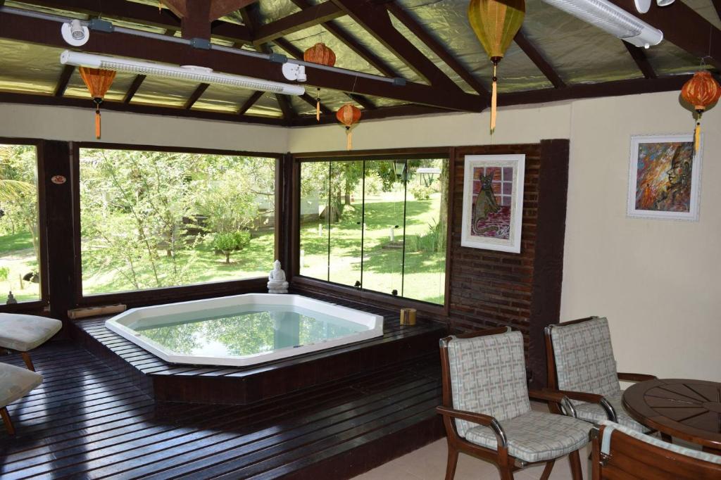 a jacuzzi tub in a room with windows at Pousada Quinta dos Doges in Valença