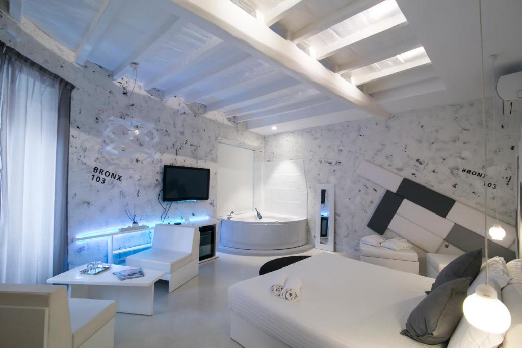 a living room with white furniture and a tv at Design&Art Pie' in Rome
