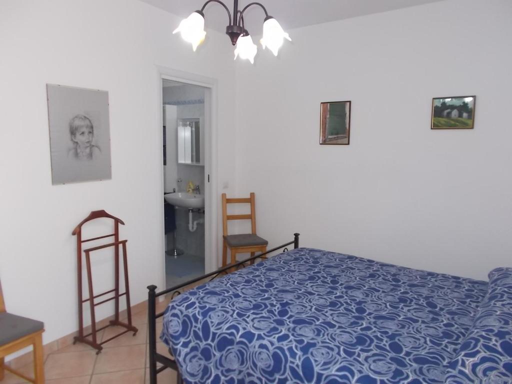 a bedroom with a bed and a table and chairs at B&B Zia Lina in Dongo