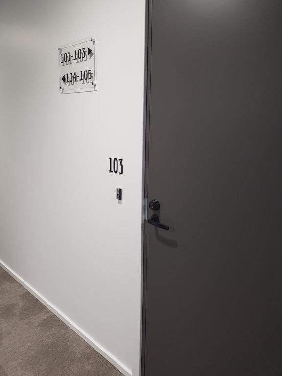 a white door with a sign on it at Naava Chalet First Floor in Ähtäri