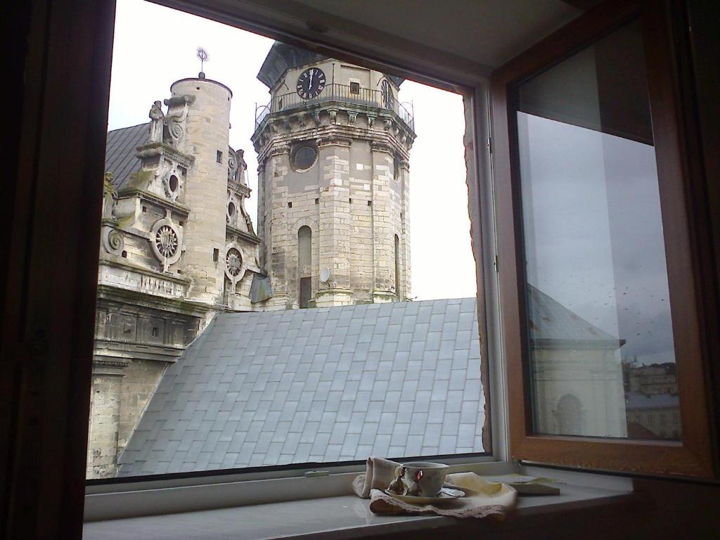 a window with a view of a castle at Lviv Amazing Rooftop Apartment in Lviv