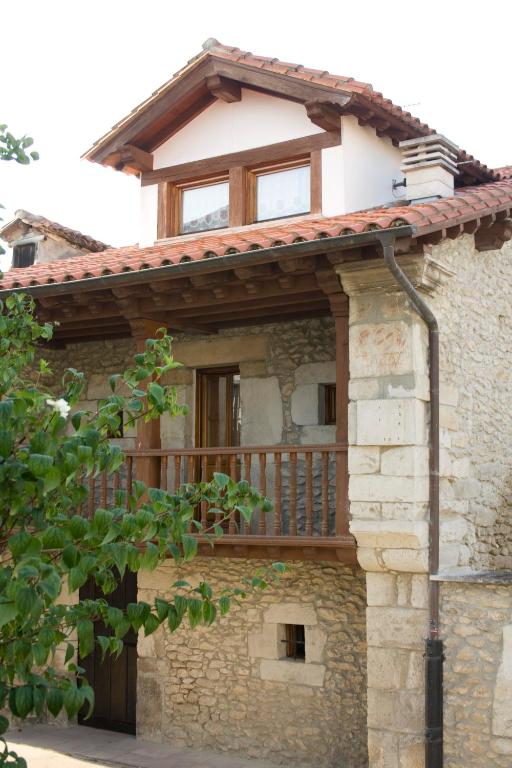 a house with a deck on the side of it at La Carriella in Colombres