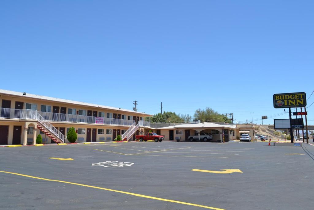 an empty parking lot in front of a hotel at Budget Inn in Needles