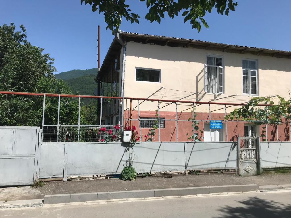 a building with a fence in front of it at Chveni Ezo in Ambrolauri