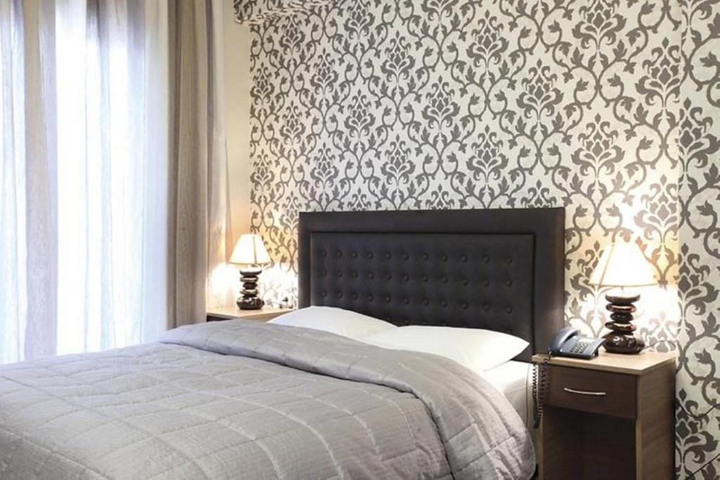 Postel nebo postele na pokoji v ubytování Delfini Hotel