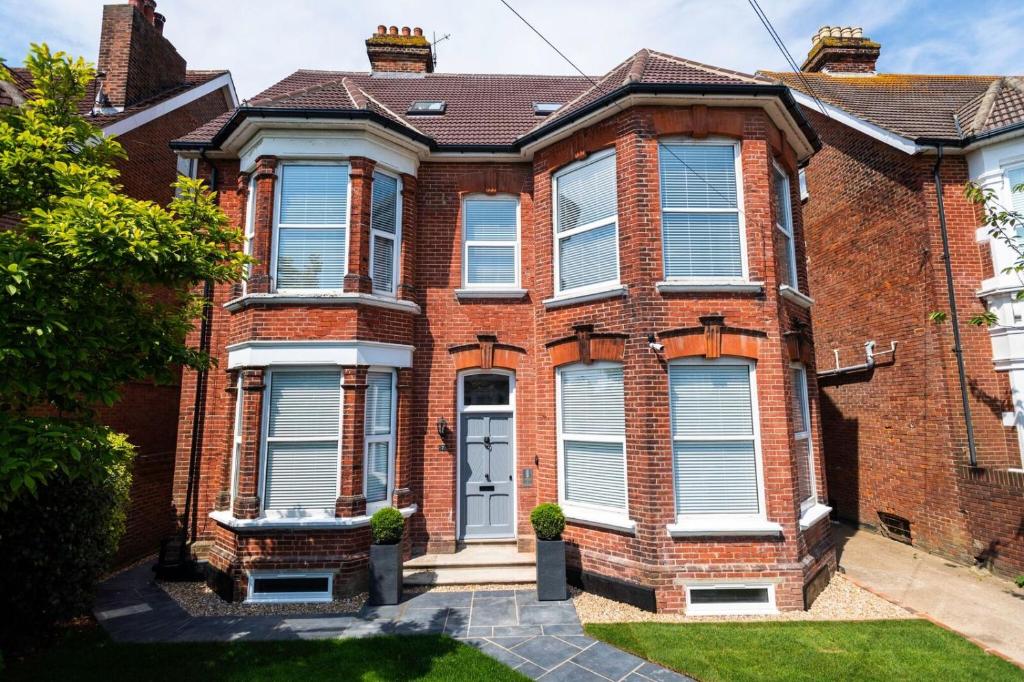 a red brick house with white windows at Southsea Studios - Luxury Seaside Apartments in Portsmouth