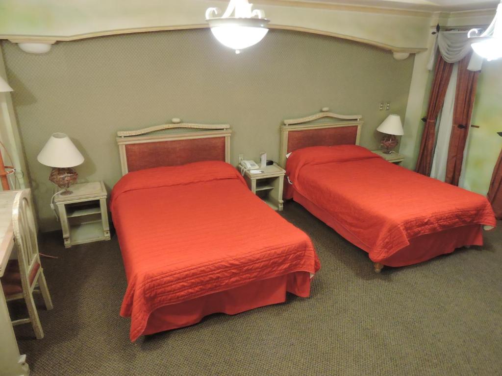Postel nebo postele na pokoji v ubytování Hotel Quinta Cesar
