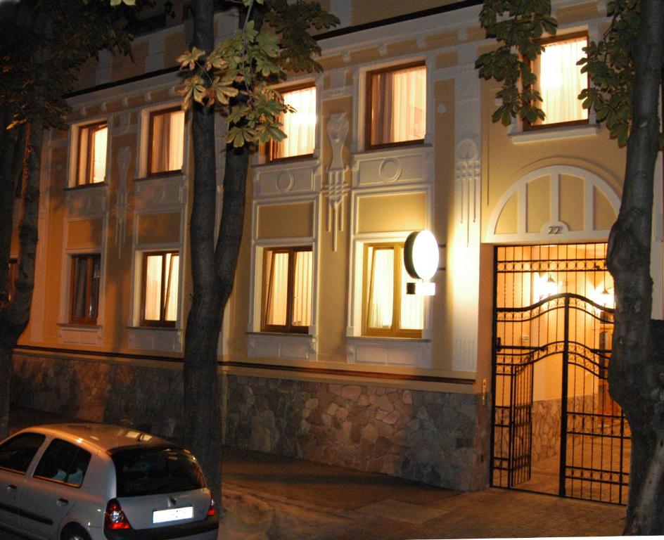 a car parked in front of a building at night at Laetitia Panzió in Kaposvár