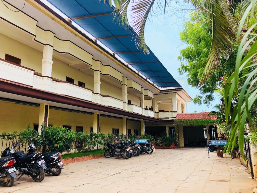 a row of motorcycles parked outside of a building at Shivalaya hotel in Pudukkottai
