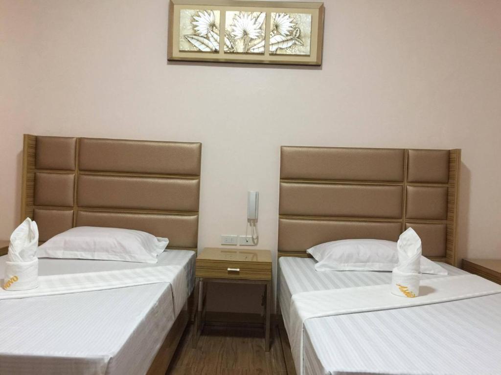Postel nebo postele na pokoji v ubytování Meaco Royal Hotel - Lipa