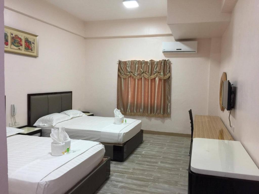 Postel nebo postele na pokoji v ubytování Meaco Royal Hotel - Lipa