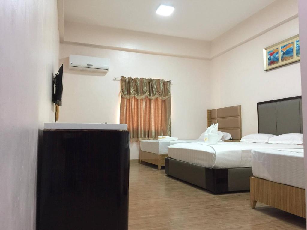 Postel nebo postele na pokoji v ubytování Meaco Royal Hotel - Lipa