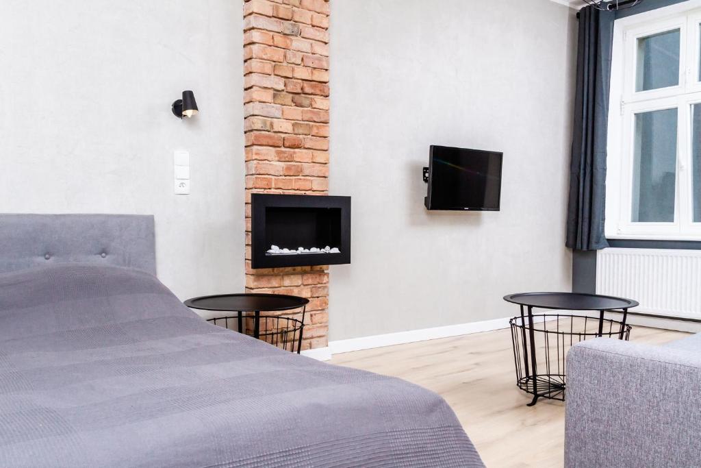 Televízia a/alebo spoločenská miestnosť v ubytovaní Apartament K2 Prosta 17