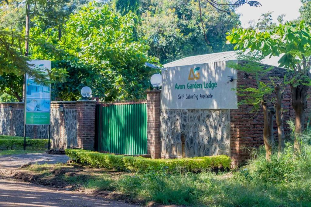 a sign for a garden village at fairy park at Avon Garden Lodge in Salima