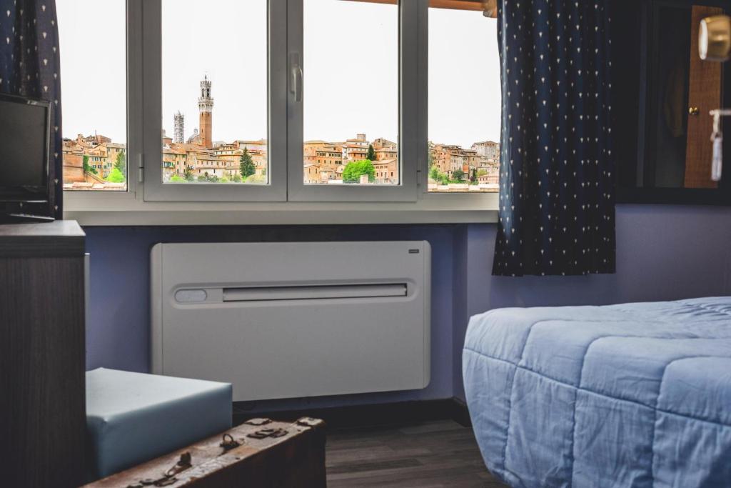 Posteľ alebo postele v izbe v ubytovaní Hotel Il Giardino