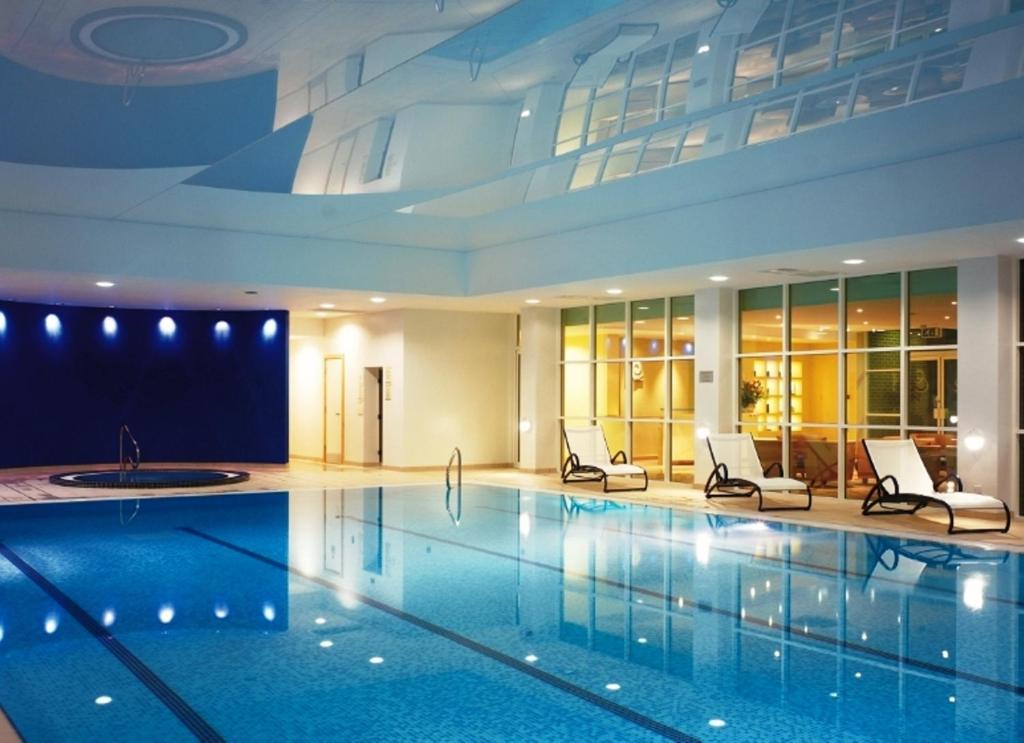 a large swimming pool with a large mirror at Regency Park Hotel, Health Club & Spa in Newbury