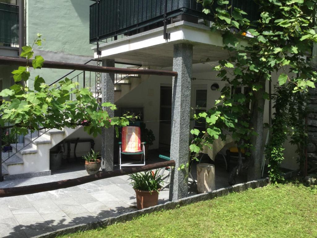 a balcony of a house with potted plants on it at Ca Evelina in Maggia