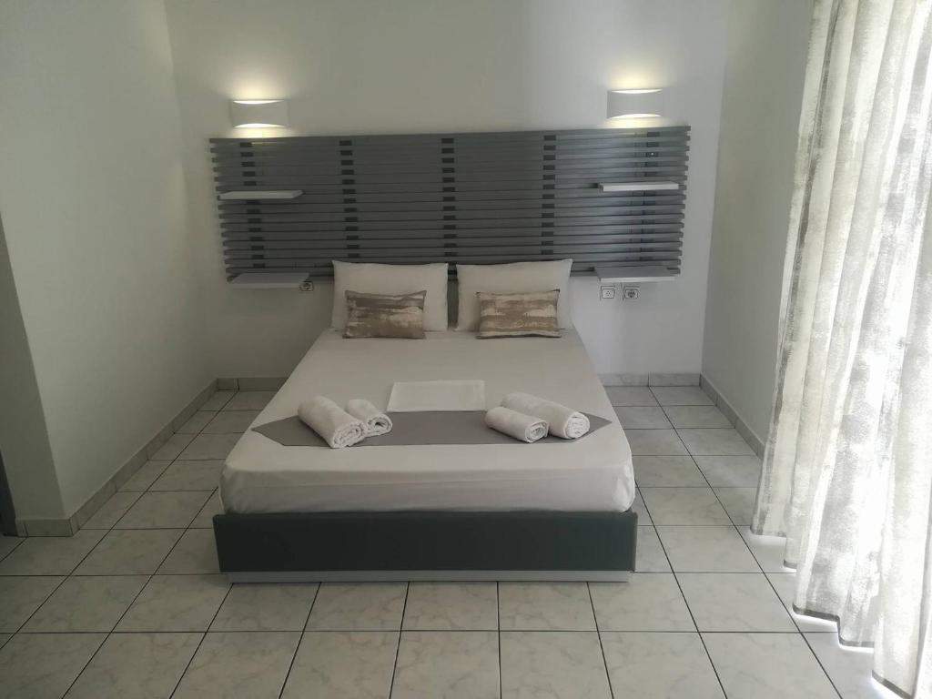 a bedroom with a large bed with two pillows at Venus De Milo in Adamas