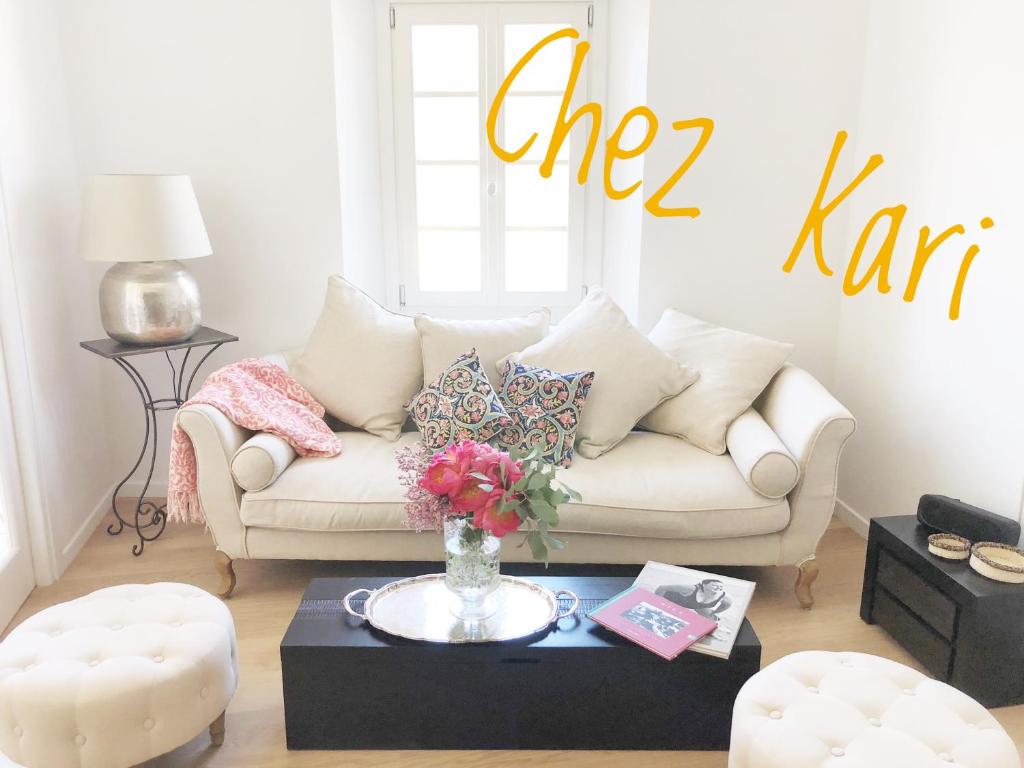 a living room with a white couch and a table at Chez Kari-top location in charming old town in Nice