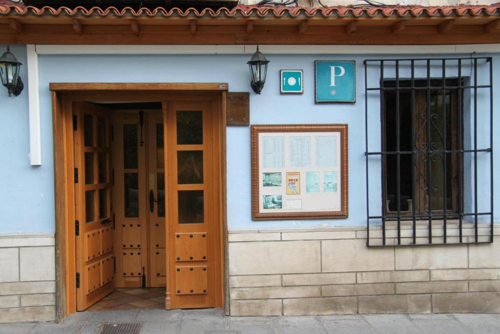 a building with two wooden doors and a window at Posada Tintes in Cuenca