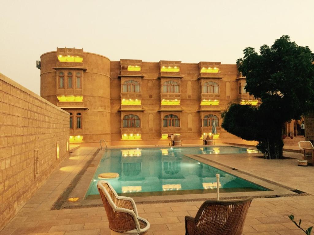 a building with a swimming pool in front of a building at Golden Haveli in Jaisalmer