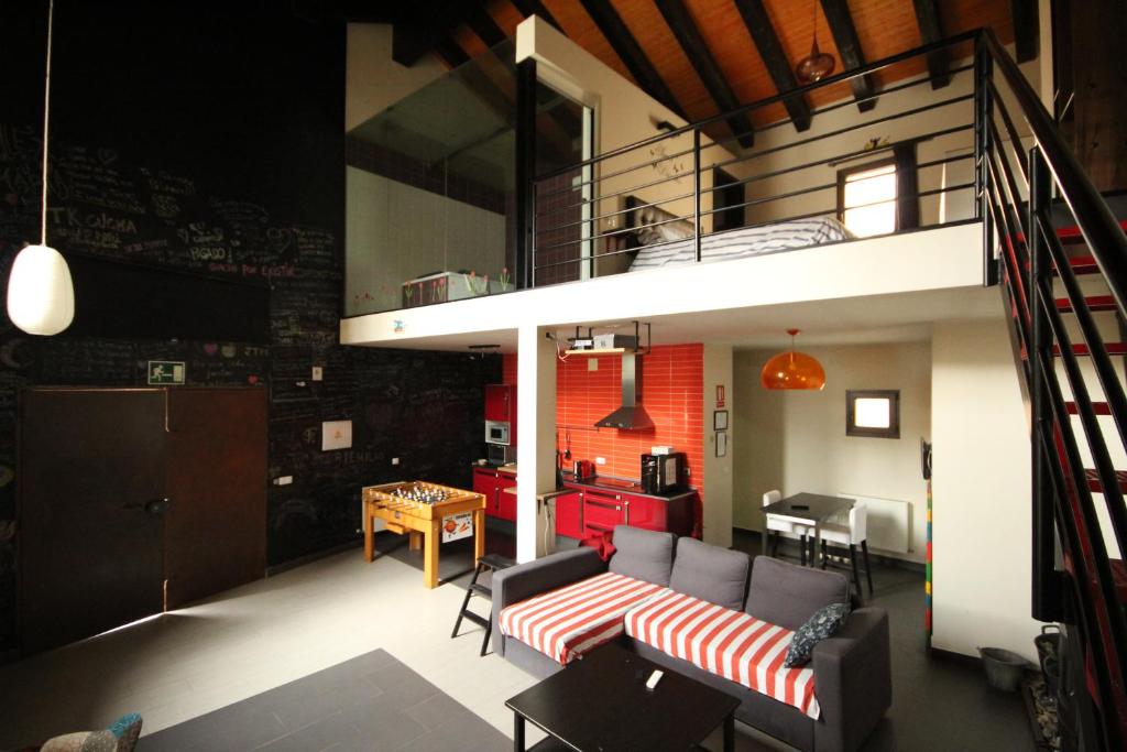 a living room with a couch and a loft at Loboratorio Rural-Cuenta hasta 3 in Umbrías