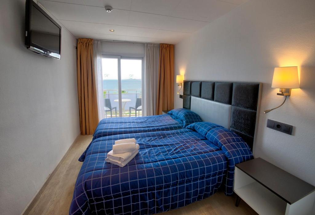 Llit o llits en una habitació de Hotel Vela