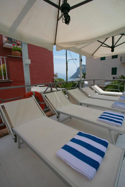 a row of chairs on a boat with an umbrella at Palatium Mari in Capri