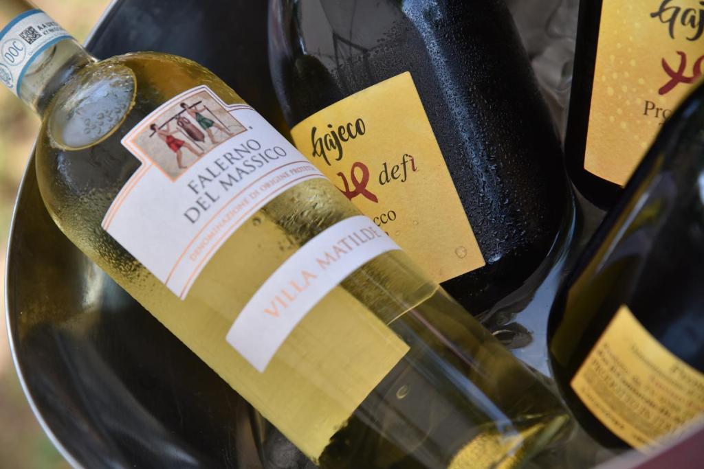 a bottle of wine sitting next to another bottle of wine at Palatium Mari in Capri